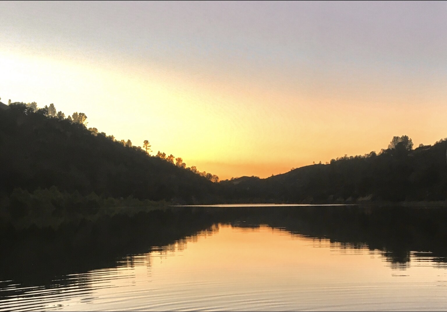 Sunset reflected on the water beside an LBEPOA campground